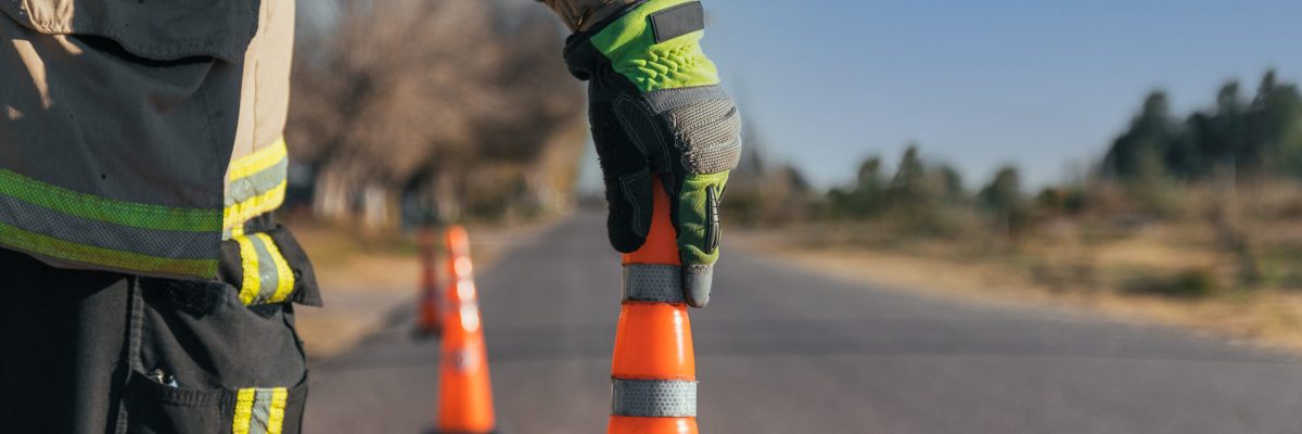 Firefighter putting cone on road